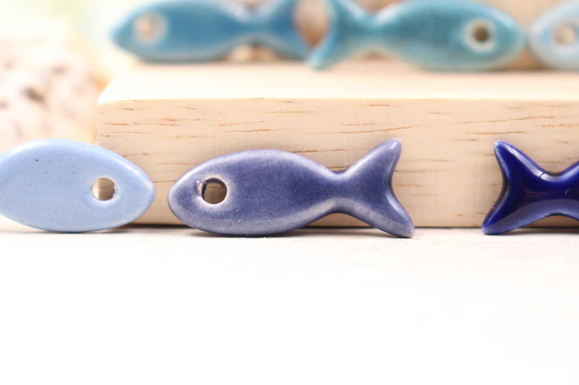 Ceramic fish charms for jewelry and accessories handmade in France by Alain Granell