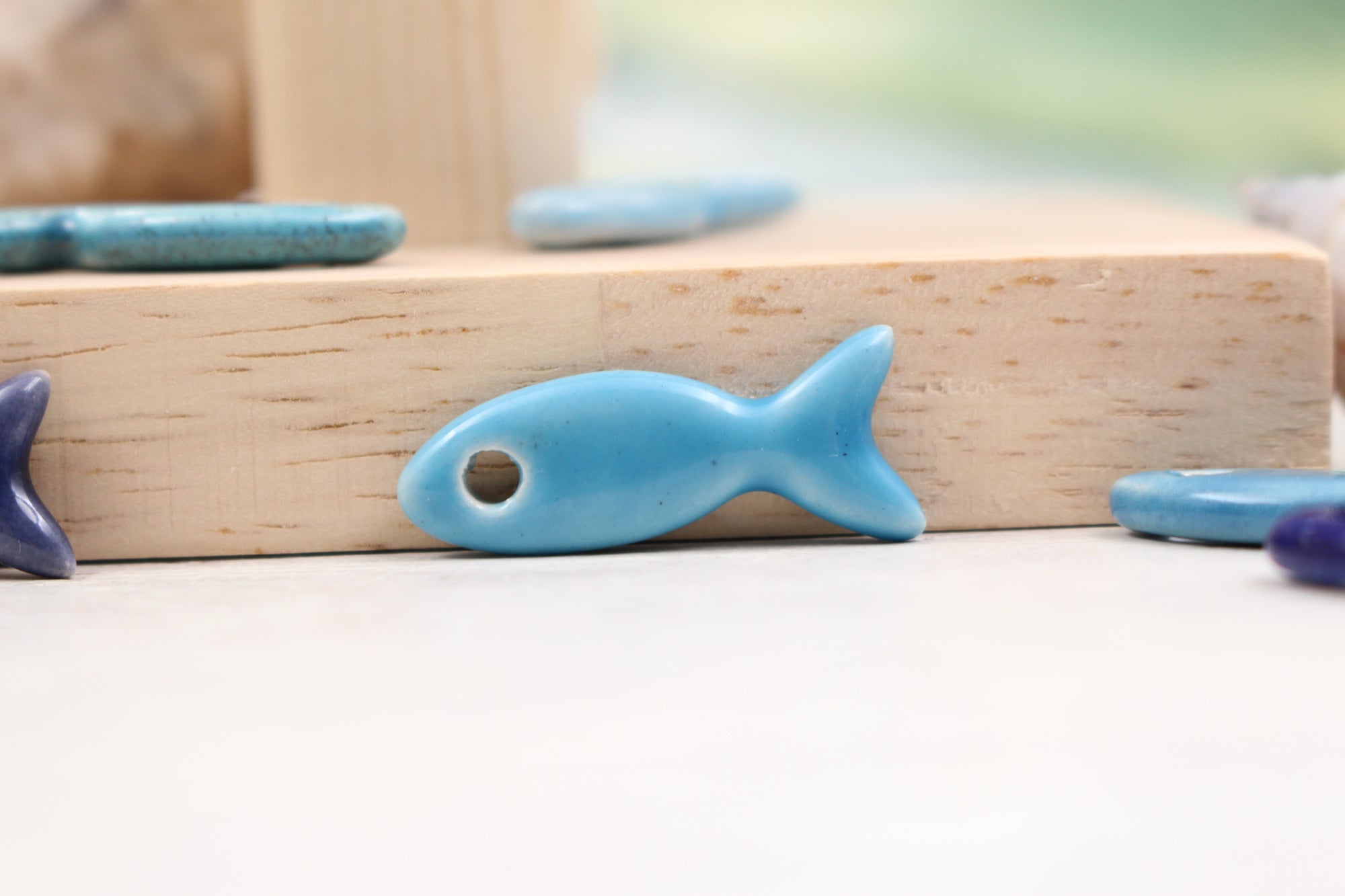 Ceramic fish charms for jewelry and accessories handmade in France by Alain Granell