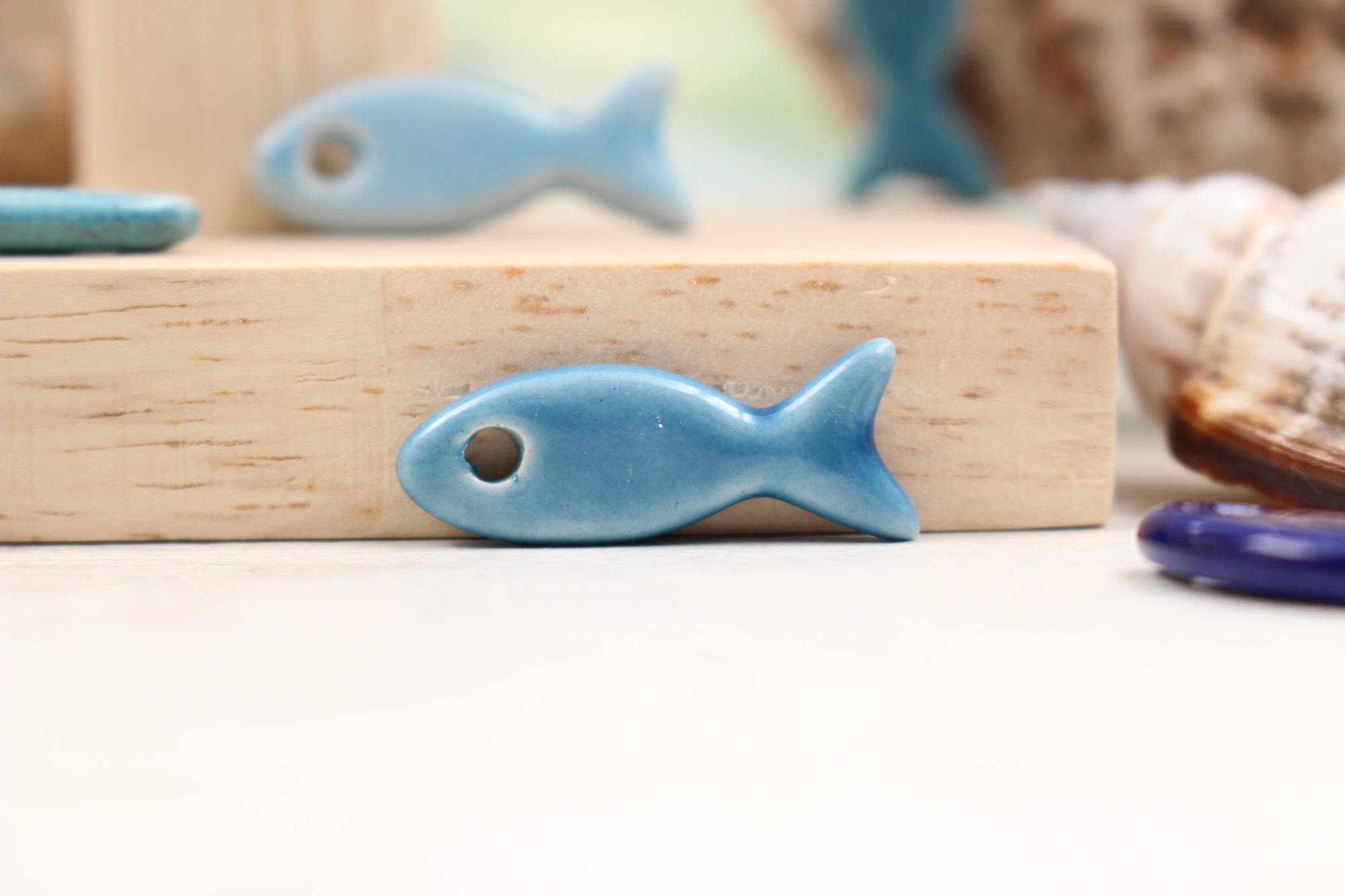 Ceramic fish charms for jewelry and accessories handmade in France by Alain Granell