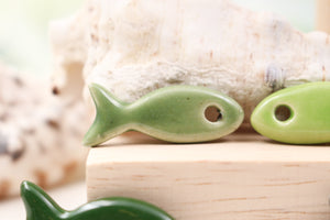 Ceramic fish charms for jewelry and accessories handmade in France by Alain Granell