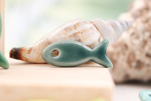 Ceramic fish charms for jewelry and accessories handmade in France by Alain Granell
