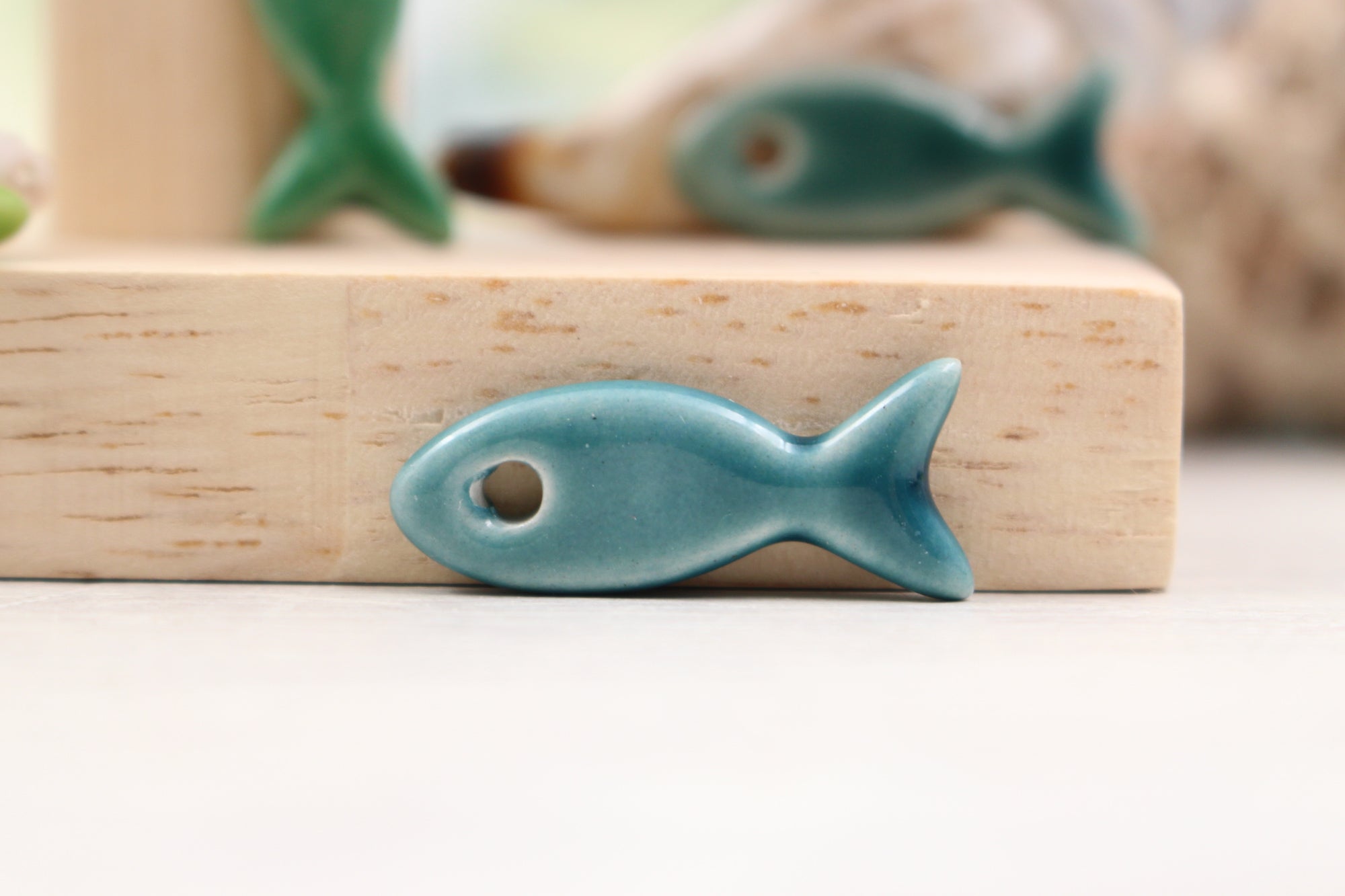 Ceramic fish charms for jewelry and accessories handmade in France by Alain Granell
