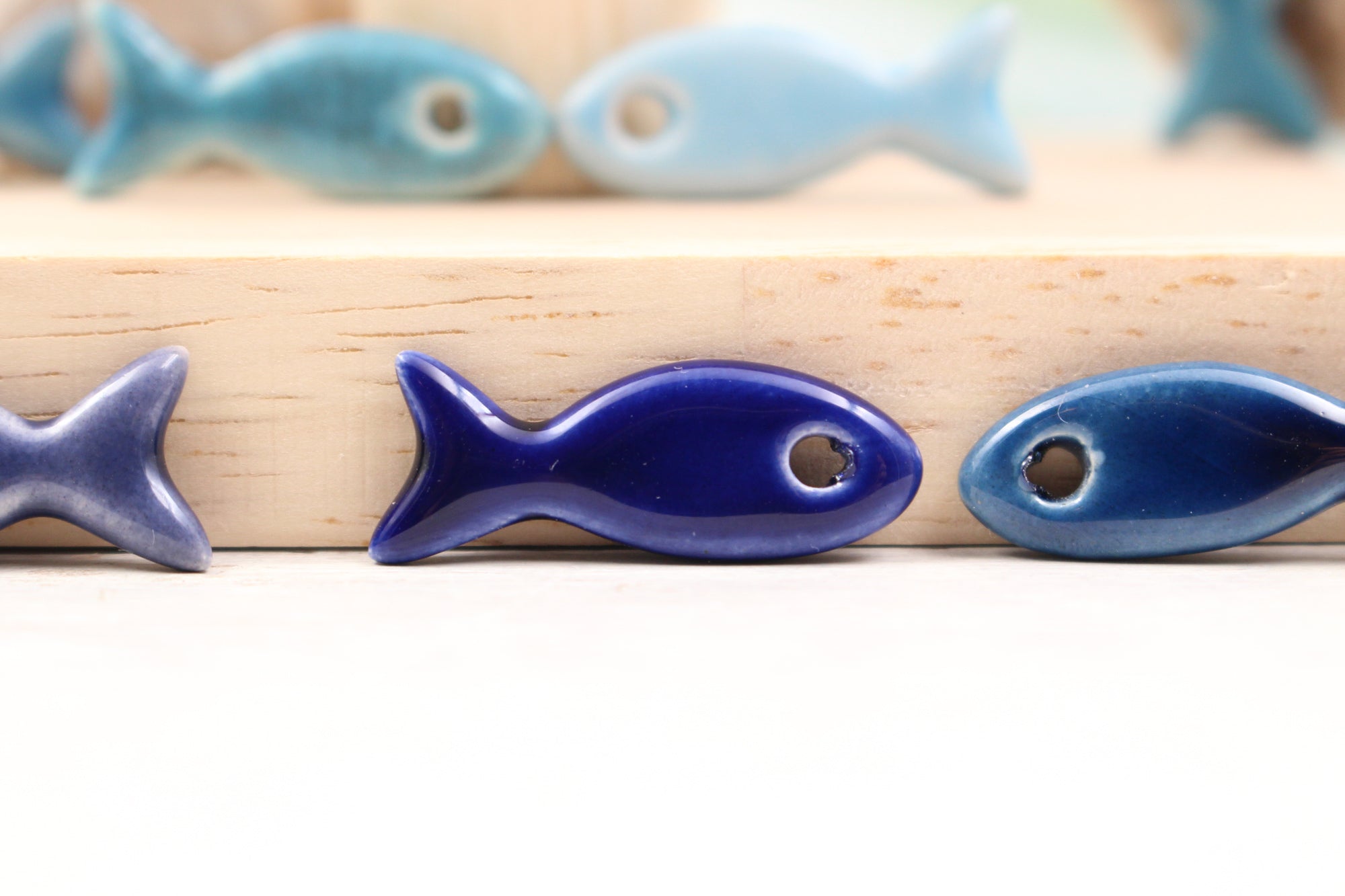 Ceramic fish charms for jewelry and accessories handmade in France by Alain Granell