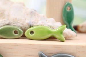 Ceramic fish charms for jewelry and accessories handmade in France by Alain Granell
