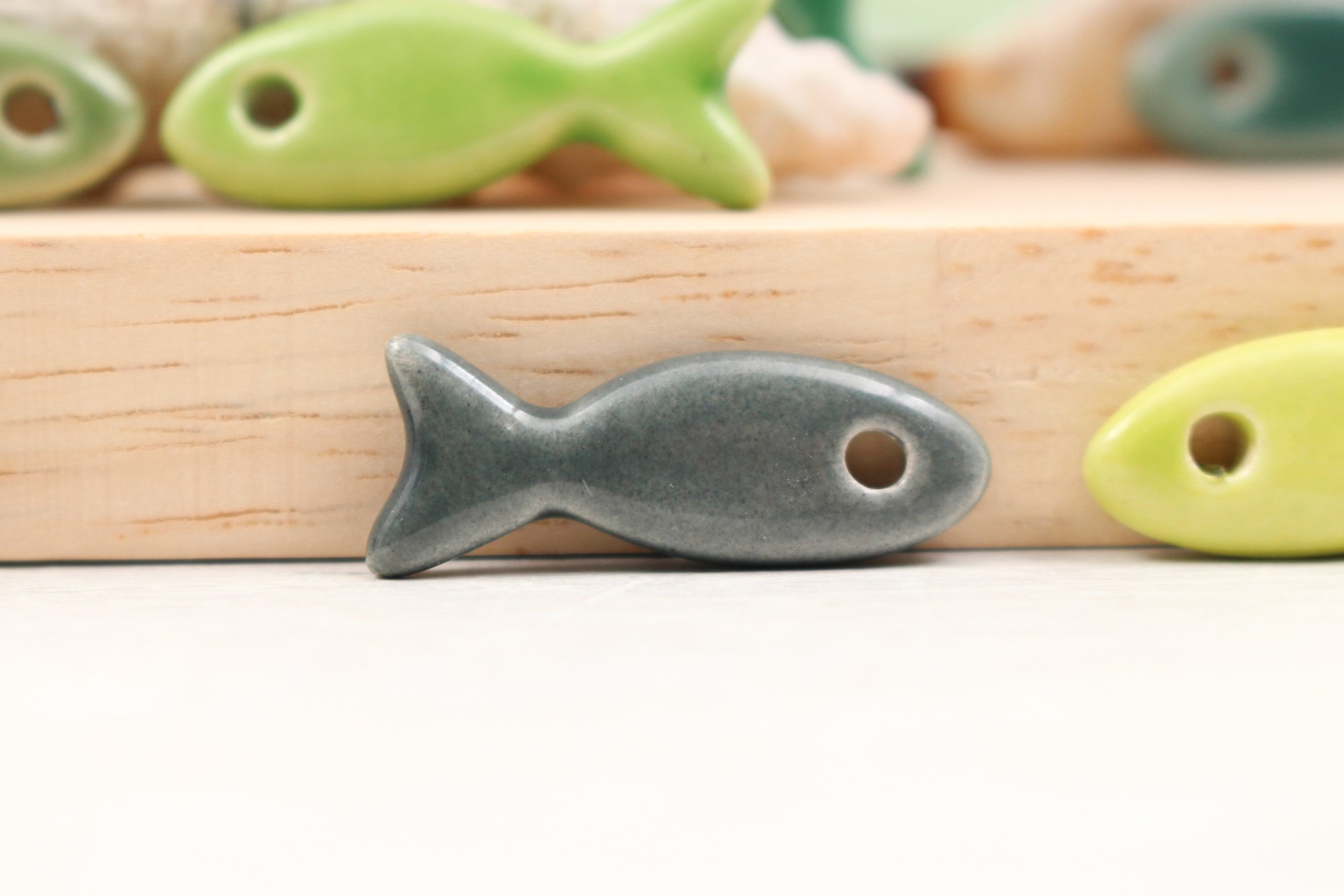 Ceramic fish charms for jewelry and accessories handmade in France by Alain Granell
