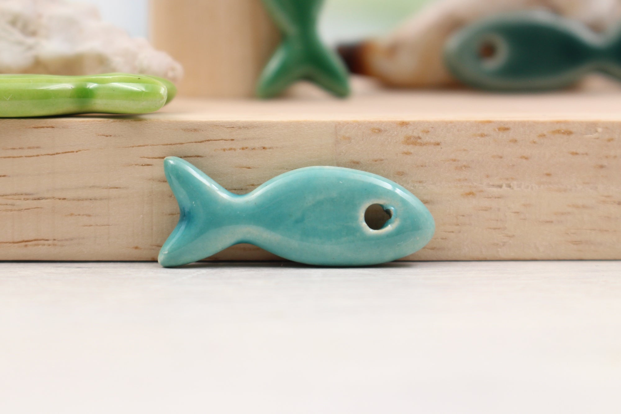 Ceramic fish charms for jewelry and accessories handmade in France by Alain Granell