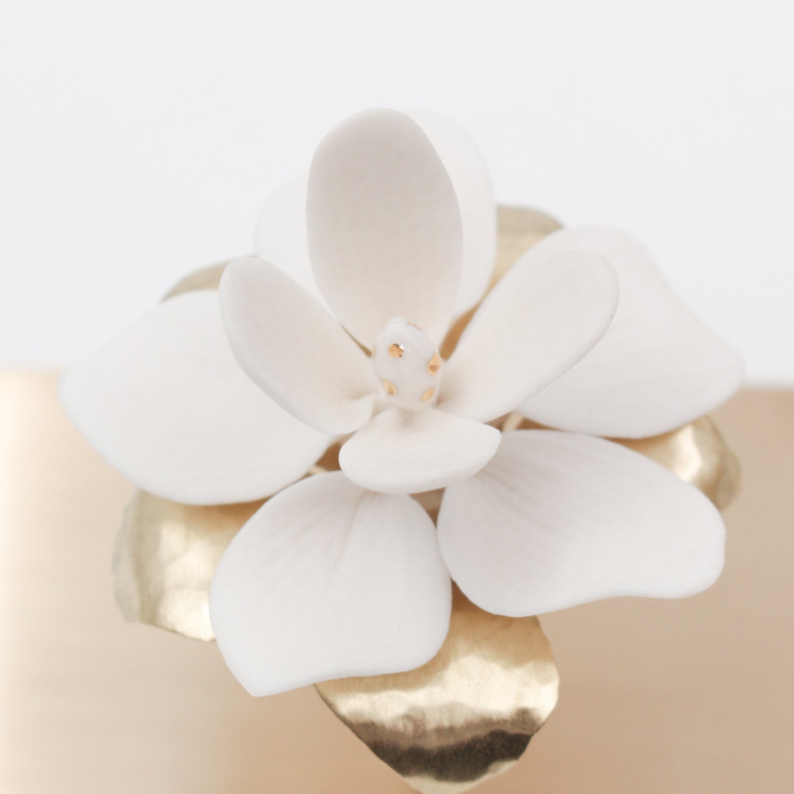 Porcelain magnolia flowers on brass tree for interior decoration - by Alain Granell